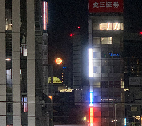 ビルとビルの間に見える満月
